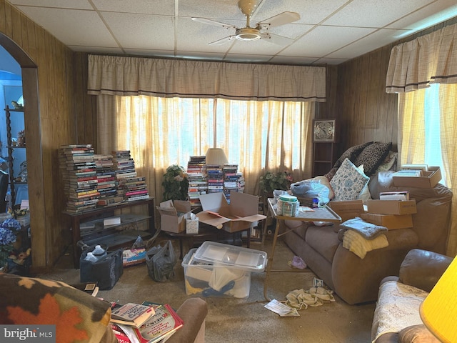 67 Fairfield St, Carlisle, PA 17013 - living area featuring wooden walls, ceiling fan, arched walkways, a drop ceiling, and carpet
