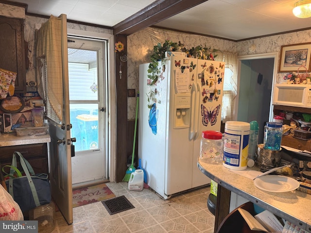 67 Fairfield St, Carlisle, PA 17013 - kitchen featuring white appliances, crown molding, plenty of natural light, light countertops, and wallpapered walls