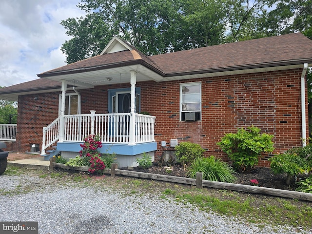 300 N Orchard Rd, Vineland, NJ 08360 - view of front of home featuring brick siding, a porch, roof with shingles, and cooling unit