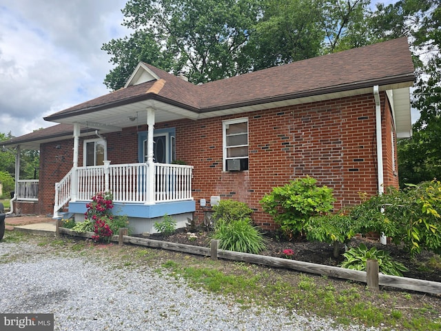 300 N Orchard Rd, Vineland, NJ 08360 - view of front facade with a porch, brick siding, roof with shingles, and cooling unit
