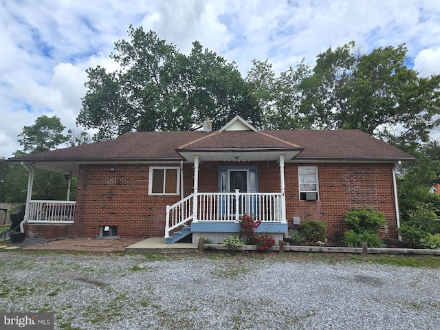 300 N Orchard Rd, Vineland, NJ 08360 - view of front of home with brick siding, cooling unit, a shingled roof, and covered porch