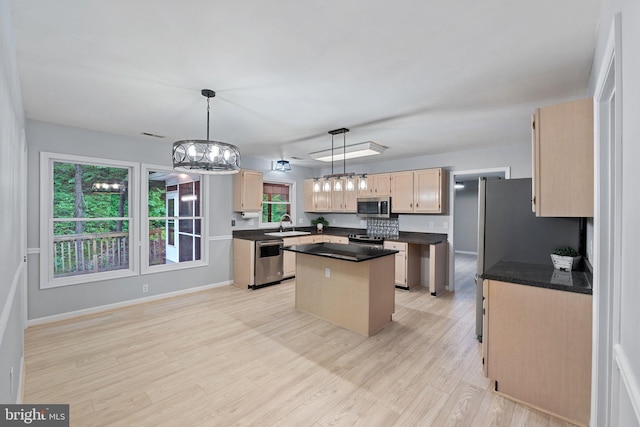 1420 Fishel Rd, Winchester, VA 22602 - kitchen featuring appliances with stainless steel finishes, a kitchen island, a chandelier, a sink, and dark countertops