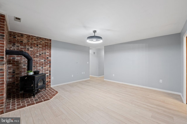 1420 Fishel Rd, Winchester, VA 22602 - unfurnished living room featuring a wood stove, wood finished floors, and baseboards