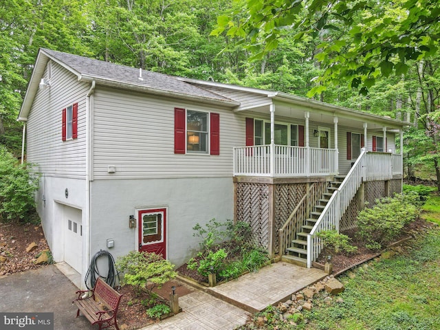 1420 Fishel Rd, Winchester, VA 22602 - view of front of home with a porch, an attached garage, stairway, driveway, and stucco siding
