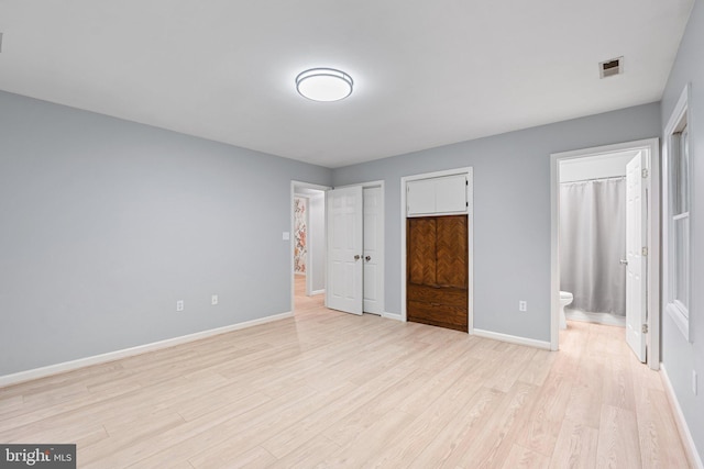 1420 Fishel Rd, Winchester, VA 22602 - unfurnished bedroom with light wood finished floors, baseboards, and ensuite bathroom