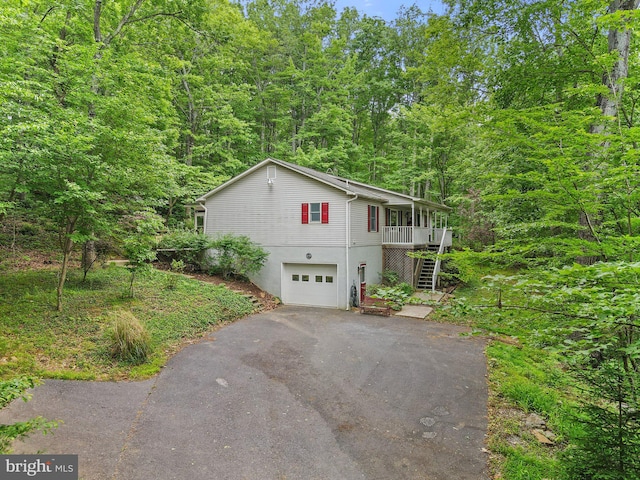 1420 Fishel Rd, Winchester, VA 22602 - view of front facade with driveway, stairs, an attached garage, and a view of trees