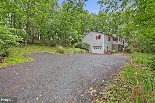 1420 Fishel Rd, Winchester, VA 22602 - view of side of property with stairway, asphalt driveway, a garage, and a porch