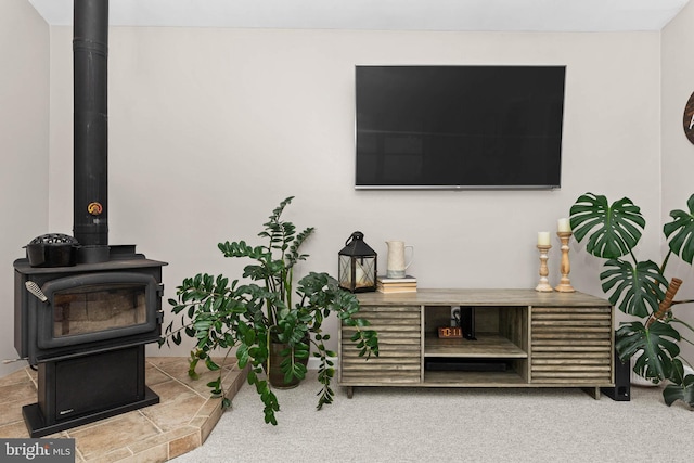 808 Scotia Rd, Philadelphia, PA 19128 - living area with a wood stove and carpet flooring