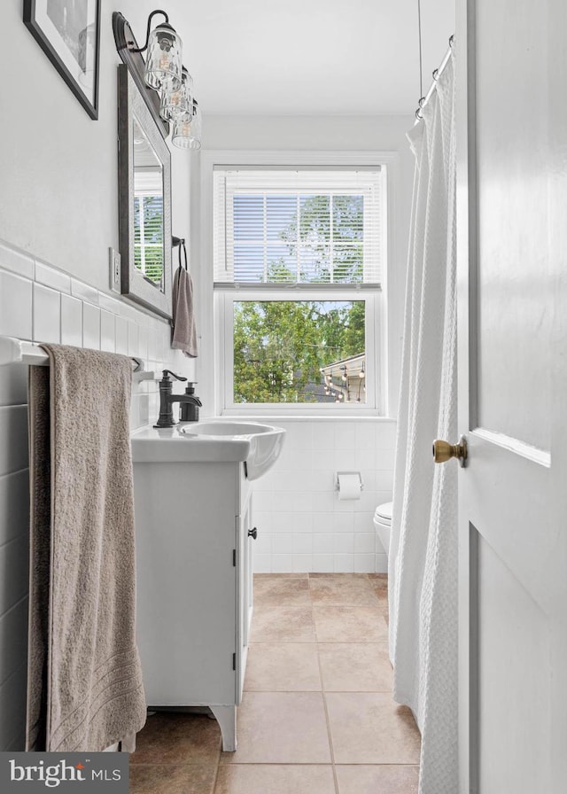 808 Scotia Rd, Philadelphia, PA 19128 - full bathroom featuring tile walls, vanity, tile patterned floors, toilet, and healthy amount of natural light