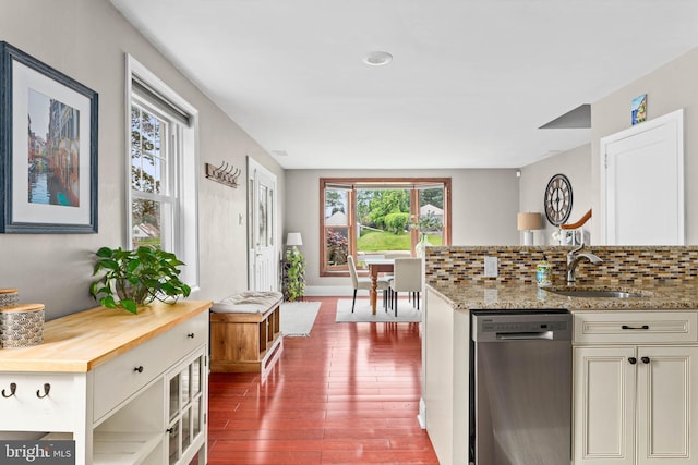 808 Scotia Rd, Philadelphia, PA 19128 - kitchen with stainless steel dishwasher, a sink, dark wood finished floors, decorative backsplash, and butcher block counters