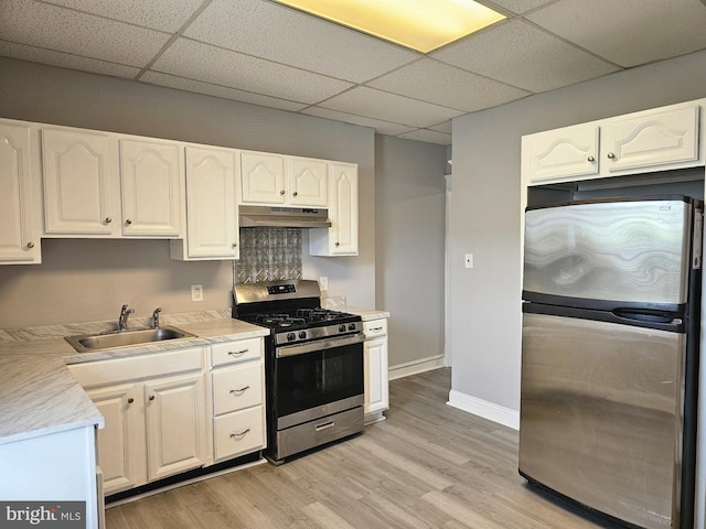 229 New Trent, Ewing, NJ 08638 - kitchen featuring appliances with stainless steel finishes, under cabinet range hood, a sink, a paneled ceiling, and white cabinetry