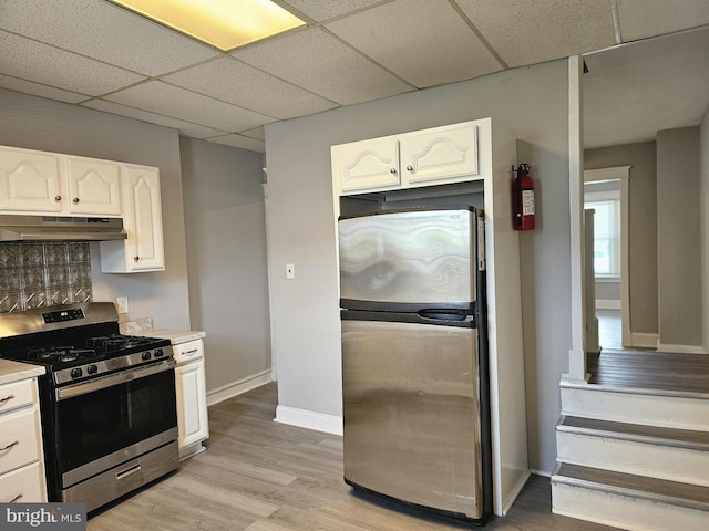 229 New Trent, Ewing, NJ 08638 - kitchen featuring stainless steel appliances, under cabinet range hood, white cabinets, a drop ceiling, and light countertops