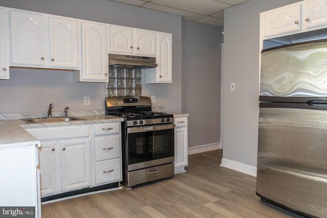 229 New Trent, Ewing, NJ 08638 - kitchen with appliances with stainless steel finishes, under cabinet range hood, a sink, a drop ceiling, and white cabinets