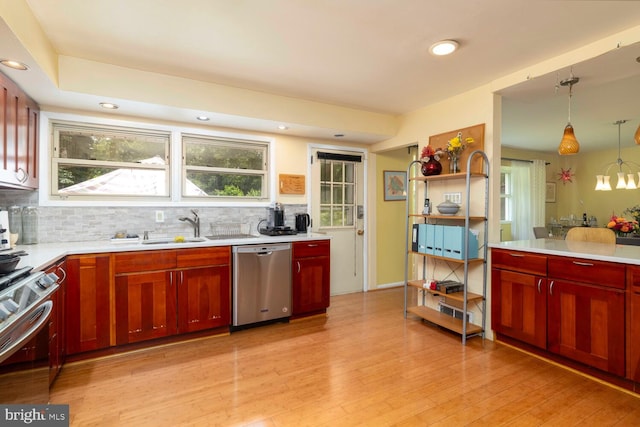 1030 Rock Creek Dr, Wyncote, PA 19095 - kitchen with appliances with stainless steel finishes, a sink, backsplash, light countertops, and light wood-style flooring