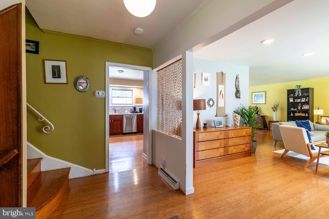 1030 Rock Creek Dr, Wyncote, PA 19095 - corridor featuring baseboard heating, light wood-type flooring, ornamental molding, stairs, and a sink