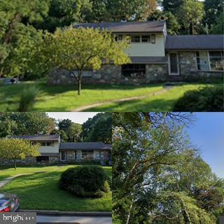 1030 Rock Creek Dr, Wyncote, PA 19095 - view of front facade with stone siding and a front yard