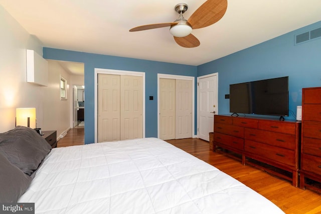 1030 Rock Creek Dr, Wyncote, PA 19095 - bedroom featuring wood finished floors, two closets, ceiling fan, and baseboards