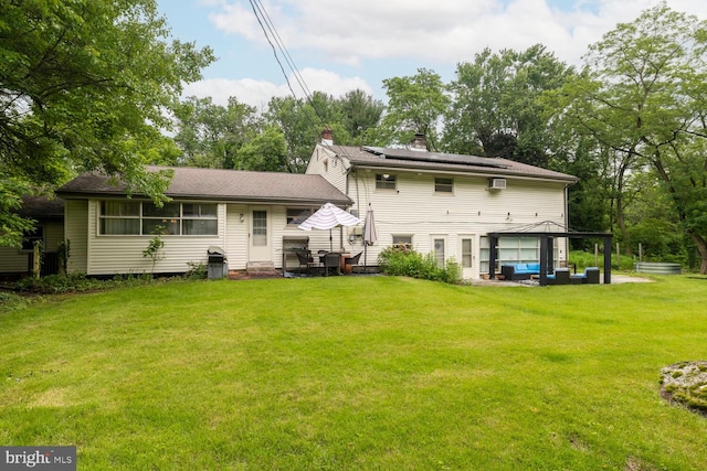 1030 Rock Creek Dr, Wyncote, PA 19095 - rear view of property featuring an outdoor hangout area, solar panels, a chimney, a lawn, and a patio area