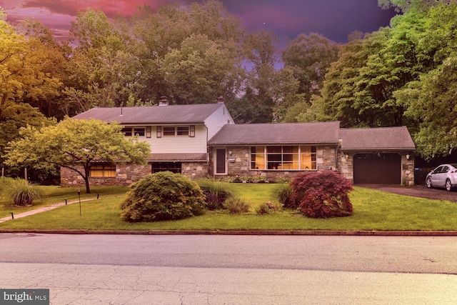 1030 Rock Creek Dr, Wyncote, PA 19095 - split level home with stone siding, an attached garage, asphalt driveway, and a front yard
