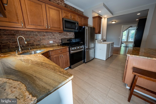 846 W 34th St W, Baltimore, MD 21211 - kitchen with stainless steel appliances, a sink, brown cabinets, stone countertops, and recessed lighting