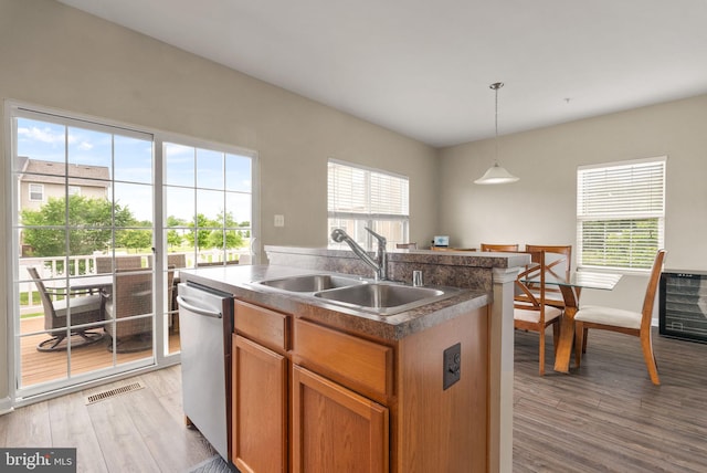 5059 Ottawa Park Pl, Waldorf, MD 20602 - kitchen with stainless steel dishwasher, a sink, light wood-type flooring, and an island with sink