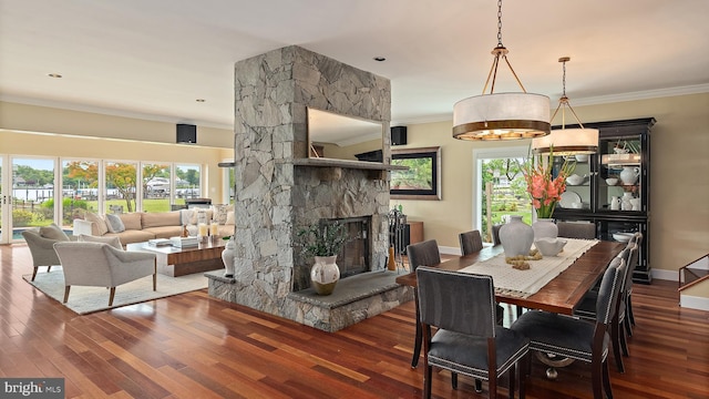 22 E Lake Dr, Annapolis, MD 21403 - dining space featuring crown molding, wood finished floors, baseboards, and a stone fireplace