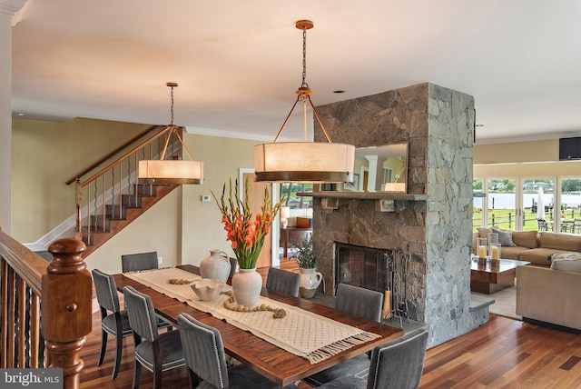 22 E Lake Dr, Annapolis, MD 21403 - dining room featuring wood finished floors, ornamental molding, stairway, and a stone fireplace