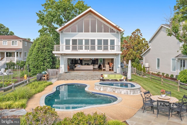 22 E Lake Dr, Annapolis, MD 21403 - back of house featuring an in-ground hot tub, a patio, board and batten siding, and outdoor dining area