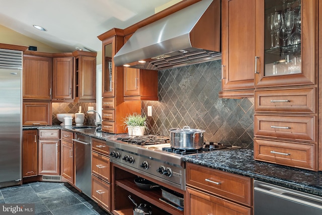 22 E Lake Dr, Annapolis, MD 21403 - kitchen featuring wall chimney exhaust hood, appliances with stainless steel finishes, a sink, brown cabinets, and lofted ceiling