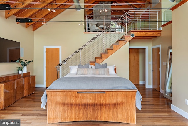 22 E Lake Dr, Annapolis, MD 21403 - bedroom featuring a high ceiling, wood finished floors, baseboards, and beam ceiling