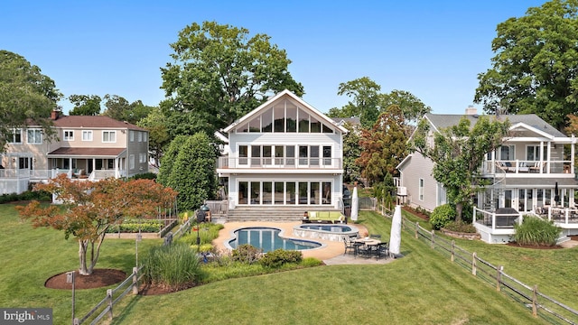 22 E Lake Dr, Annapolis, MD 21403 - rear view of house with a balcony, an in-ground hot tub, an outdoor pool, and a patio area