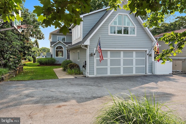 22 E Lake Dr, Annapolis, MD 21403 - view of front of home featuring asphalt driveway, a garage, a front lawn, and roof with shingles