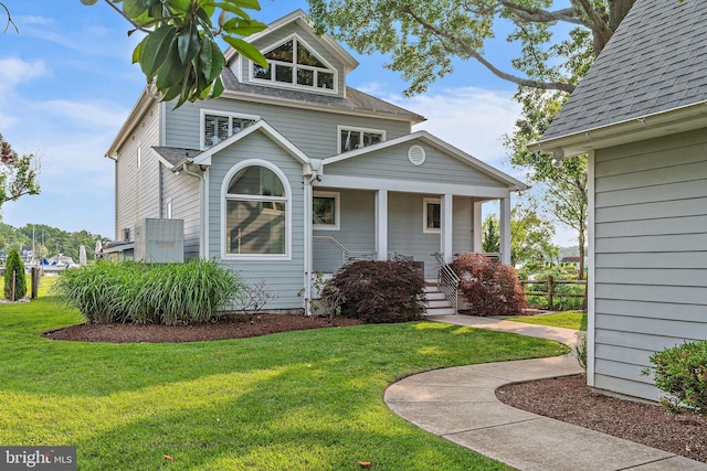 22 E Lake Dr, Annapolis, MD 21403 - view of front of property with a front yard, covered porch, and roof with shingles