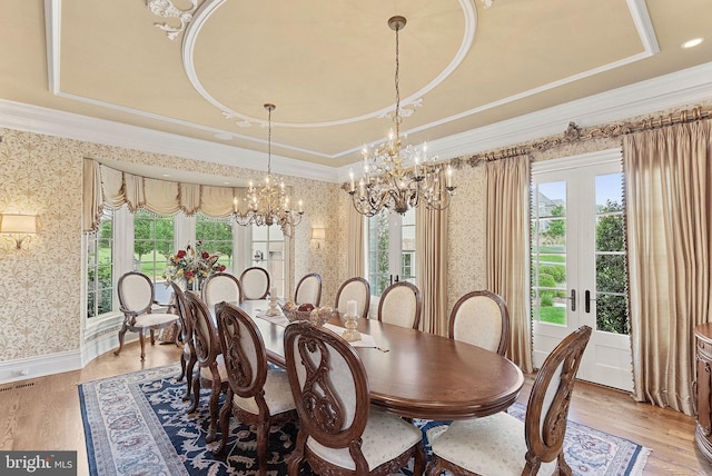 22701 Creighton Farms Dr, Leesburg, VA 20175 - dining room with a chandelier, wallpapered walls, light wood finished floors, ornamental molding, and a tray ceiling