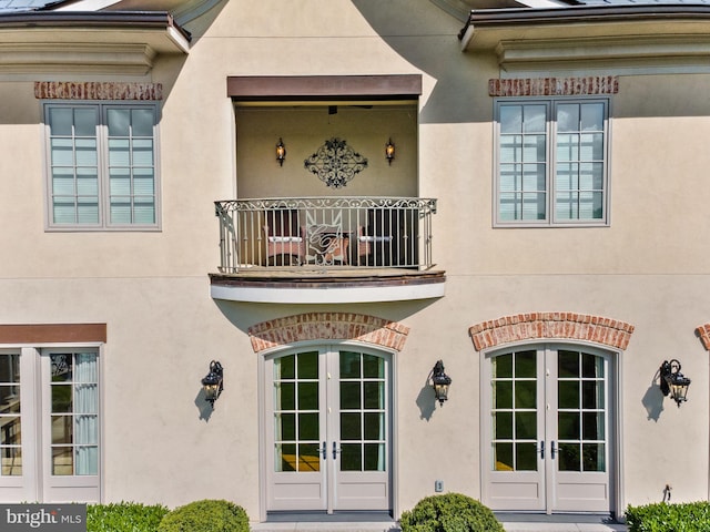 22701 Creighton Farms Dr, Leesburg, VA 20175 - property entrance with french doors, a balcony, and stucco siding
