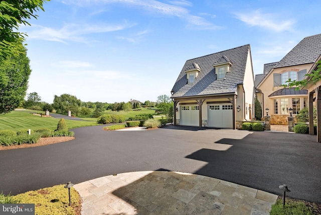 22701 Creighton Farms Dr, Leesburg, VA 20175 - view of front of home featuring asphalt driveway, a garage, and stone siding