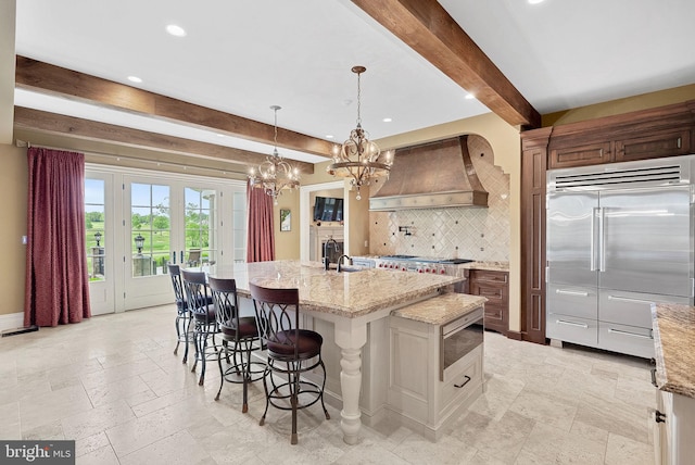 22701 Creighton Farms Dr, Leesburg, VA 20175 - kitchen featuring built in appliances, beam ceiling, custom exhaust hood, a chandelier, and tasteful backsplash