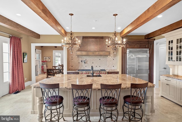 22701 Creighton Farms Dr, Leesburg, VA 20175 - kitchen with built in fridge, a chandelier, tasteful backsplash, beam ceiling, and recessed lighting