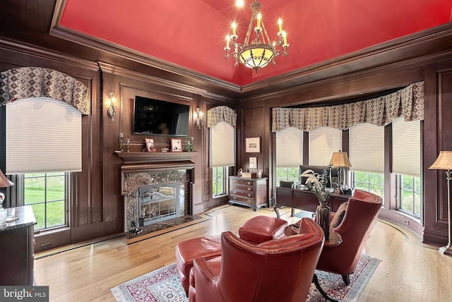 22701 Creighton Farms Dr, Leesburg, VA 20175 - living area with a premium fireplace, plenty of natural light, wood finished floors, ornamental molding, and wood walls