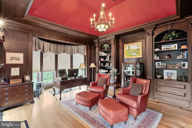 22701 Creighton Farms Dr, Leesburg, VA 20175 - sitting room featuring an office area, wood finished floors, a chandelier, ornamental molding, and built in features