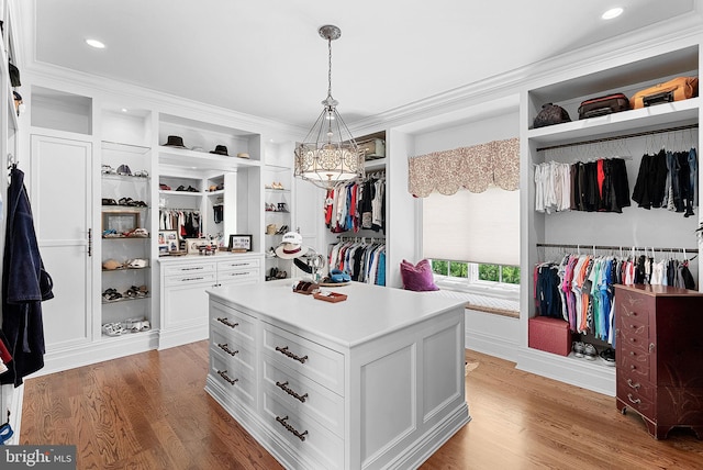 22701 Creighton Farms Dr, Leesburg, VA 20175 - walk in closet featuring light wood finished floors and a chandelier