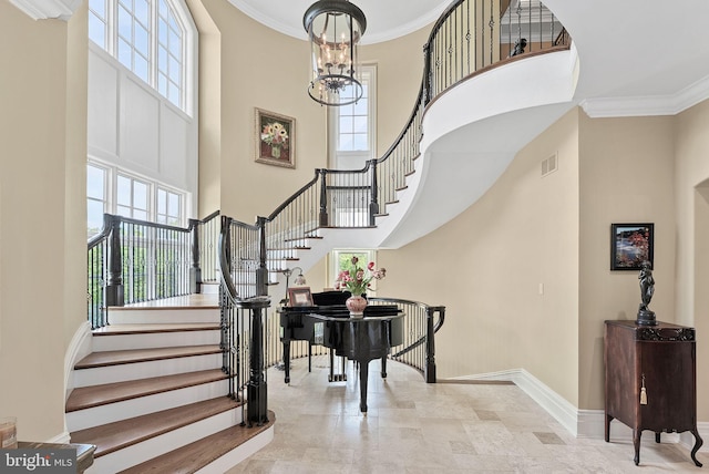 22701 Creighton Farms Dr, Leesburg, VA 20175 - staircase featuring a towering ceiling, baseboards, plenty of natural light, a chandelier, and ornamental molding