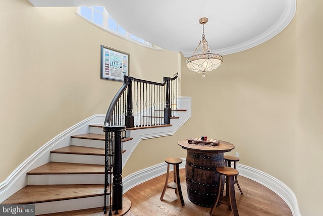 22701 Creighton Farms Dr, Leesburg, VA 20175 - stairs with wood finished floors, baseboards, and crown molding