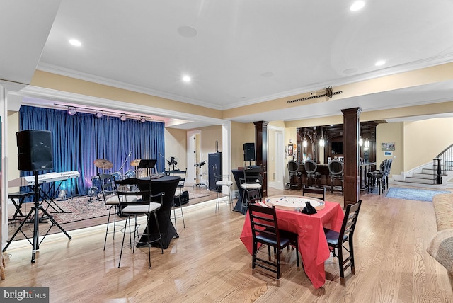 22701 Creighton Farms Dr, Leesburg, VA 20175 - dining area with decorative columns, crown molding, light wood-style flooring, recessed lighting, and stairs