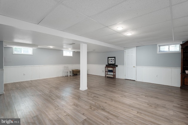 100 Weldon Way, Pennington, NJ 08534 - basement featuring a wainscoted wall, wood finished floors, a drop ceiling, and plenty of natural light