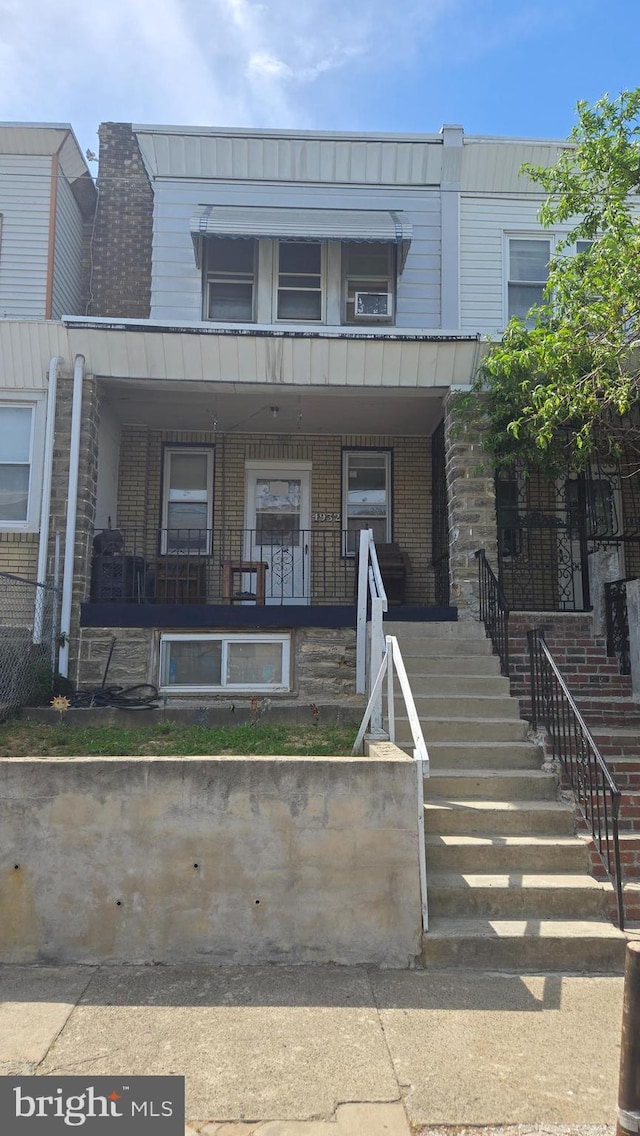 4932 Gransback St, Philadelphia, PA 19120 - view of property with brick siding, covered porch, and stairway