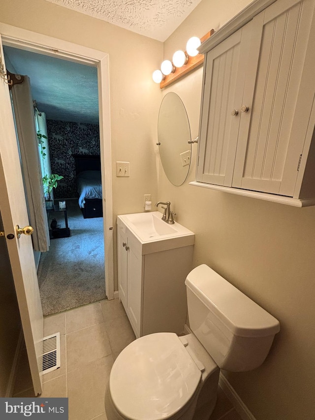 8017 Cipher Row, Jessup, MD 20794 - ensuite bathroom with vanity, a textured ceiling, and tile patterned floors
