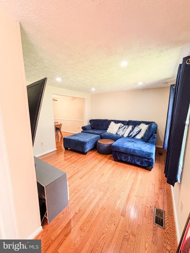 8017 Cipher Row, Jessup, MD 20794 - living area featuring a textured ceiling, wood finished floors, and recessed lighting