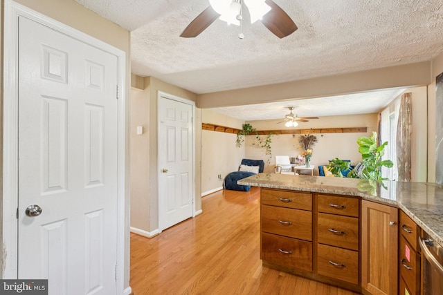 8017 Cipher Row, Jessup, MD 20794 - kitchen with a ceiling fan, a textured ceiling, light wood-type flooring, brown cabinets, and a peninsula
