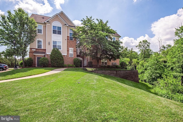 43415 Madison Renee Ter Unit 120, Ashburn, VA 20147 - view of front of property featuring brick siding and a front yard